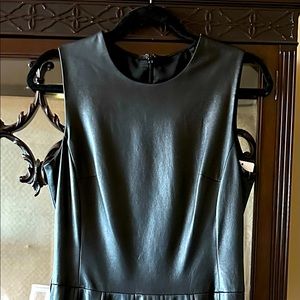 Genuine leather dress with pleated skirt and belt loops but no belt.